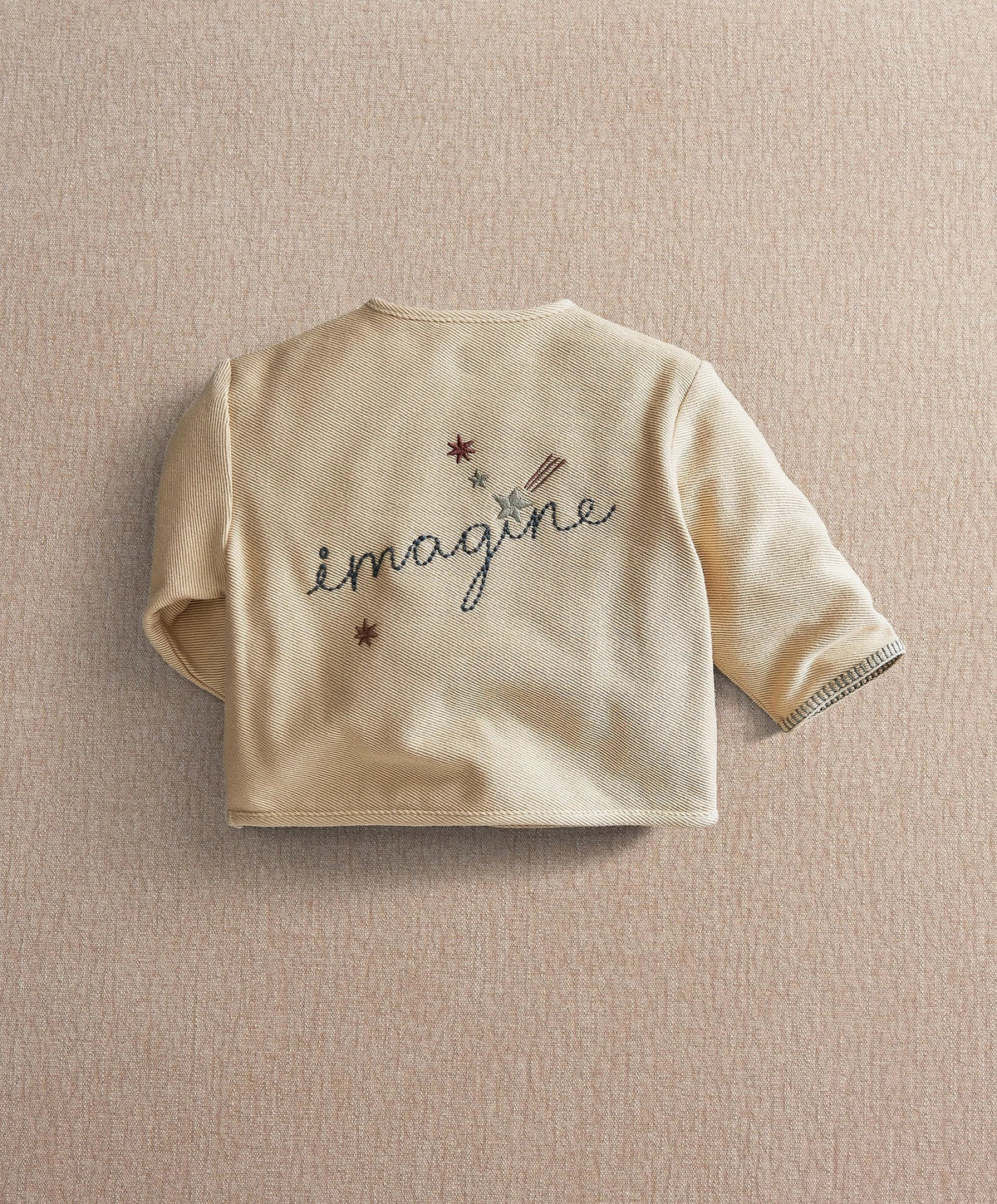 Cream kids jacket with embroidered imagine logo on back and short button placket