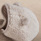 Cream borg hood with teddy-pile texture and ribbed trim.