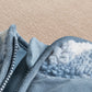 Fleece-lined pramsuit cuff with blue fabric trim and stitched seam detail
