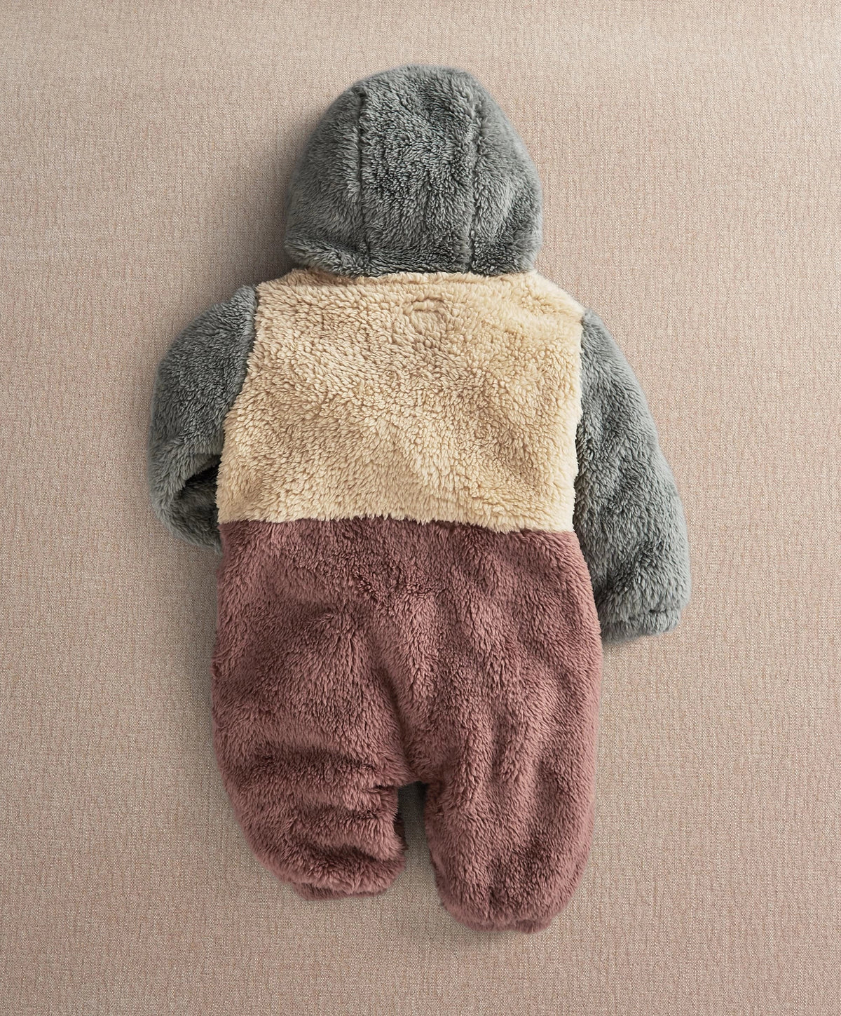 Color-block pramsuit hooded back view, gray hood and sleeves with beige and plum legs