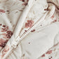Ditsy print pramsuit close-up with full-length zip and floral knit lining