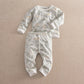 Dinosaur print jersey pyjamas set with long-sleeve top and matching pants, white cuffs
