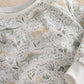 Dinosaur jersey pyjamas top close-up with ribbed crew neck and long sleeves