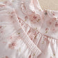 Pale pink floral pyjama top with ruffled collar and button placket, long sleeves