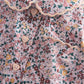 Floral woven pajama top close-up with buttons and ruffled collar