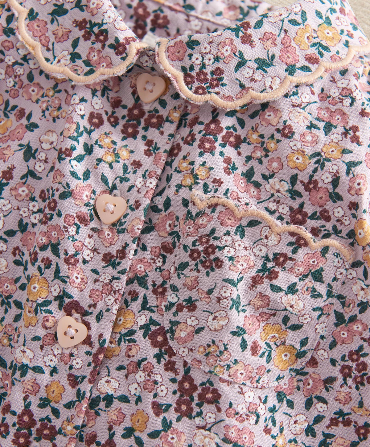 Floral woven pajama top close-up with buttons and ruffled collar