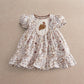Floral dress with puff sleeves, embroidered bib and tiered ruffle skirt