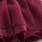 Burgundy pleated skirt hem with layered ruffle tiers