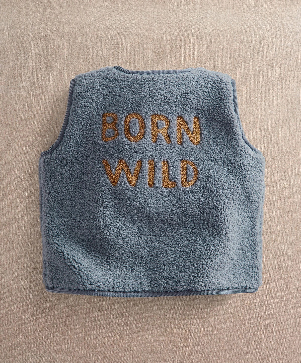 Blue fleece sleeveless gilet with 'BORN WILD' back text