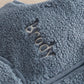 Blue sherpa fleece gilet close-up of 'BORN' applique and rib trim