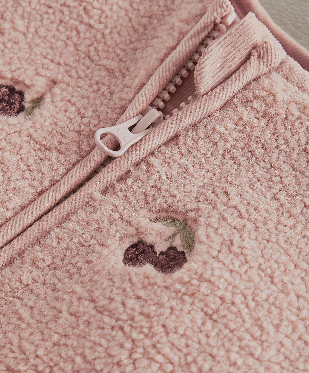 Pink teddy gilet with zipper and stitched patch detail
