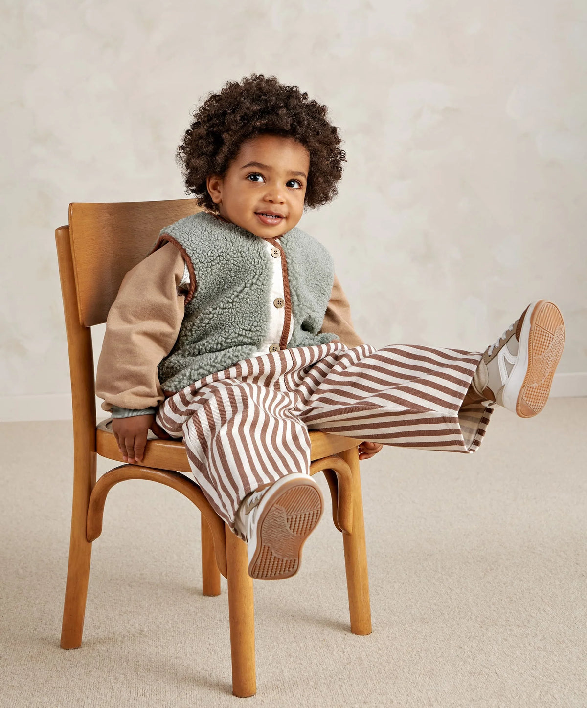 Kids borg gilet vest with fluffy light green-gray texture, brown trim, and four-button front