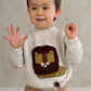 Children's lion knit jumper, speckled cream with brown and yellow lion graphic