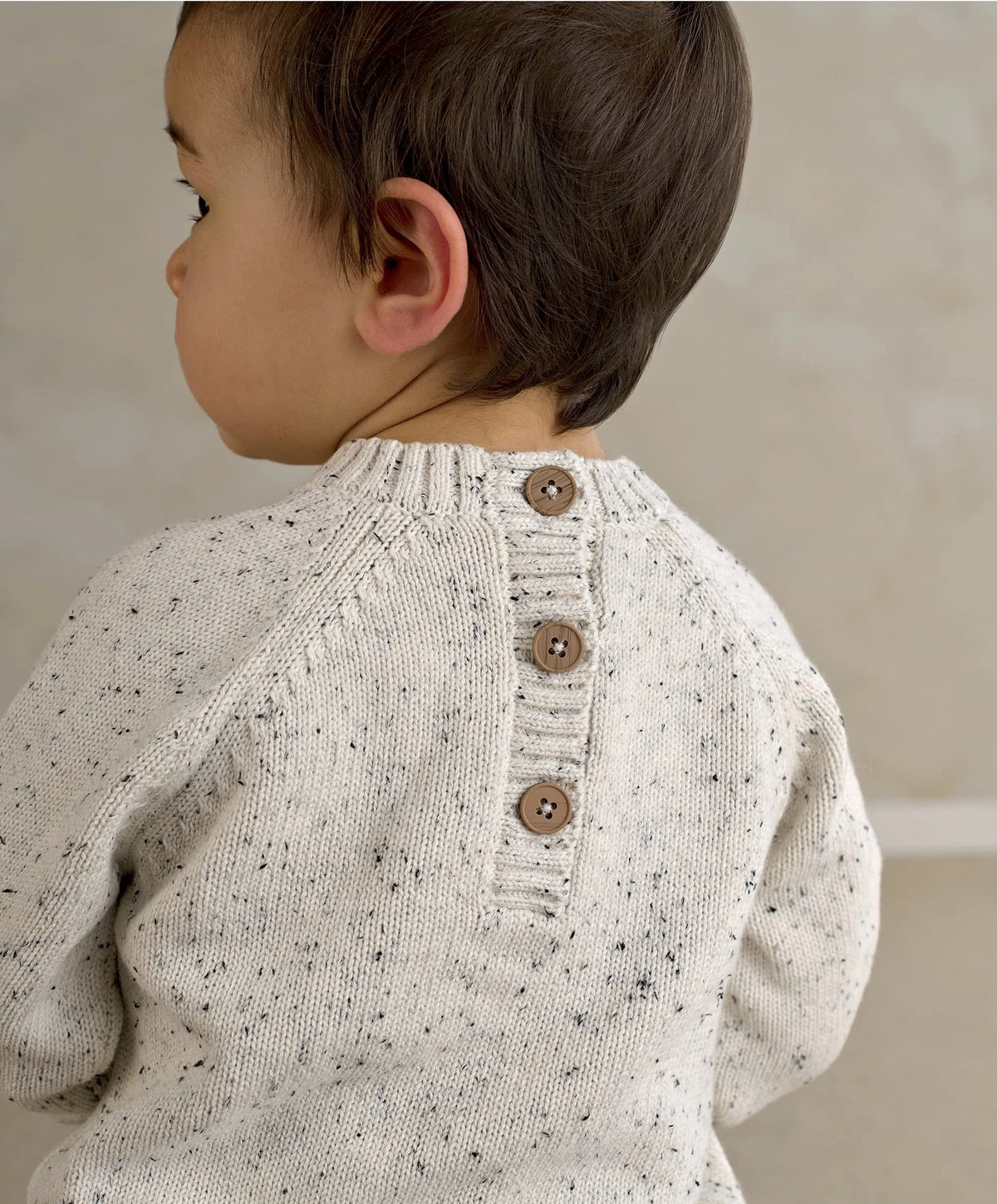 Children's lion knit jumper back view, cream speckled with buttoned back placket