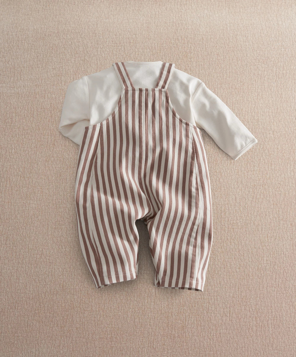 Striped dungaree set flat lay, long sleeves, brown-and-cream vertical stripe overall legs