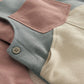 Color-block dungarees close-up: round buttons and stitched square chest pocket