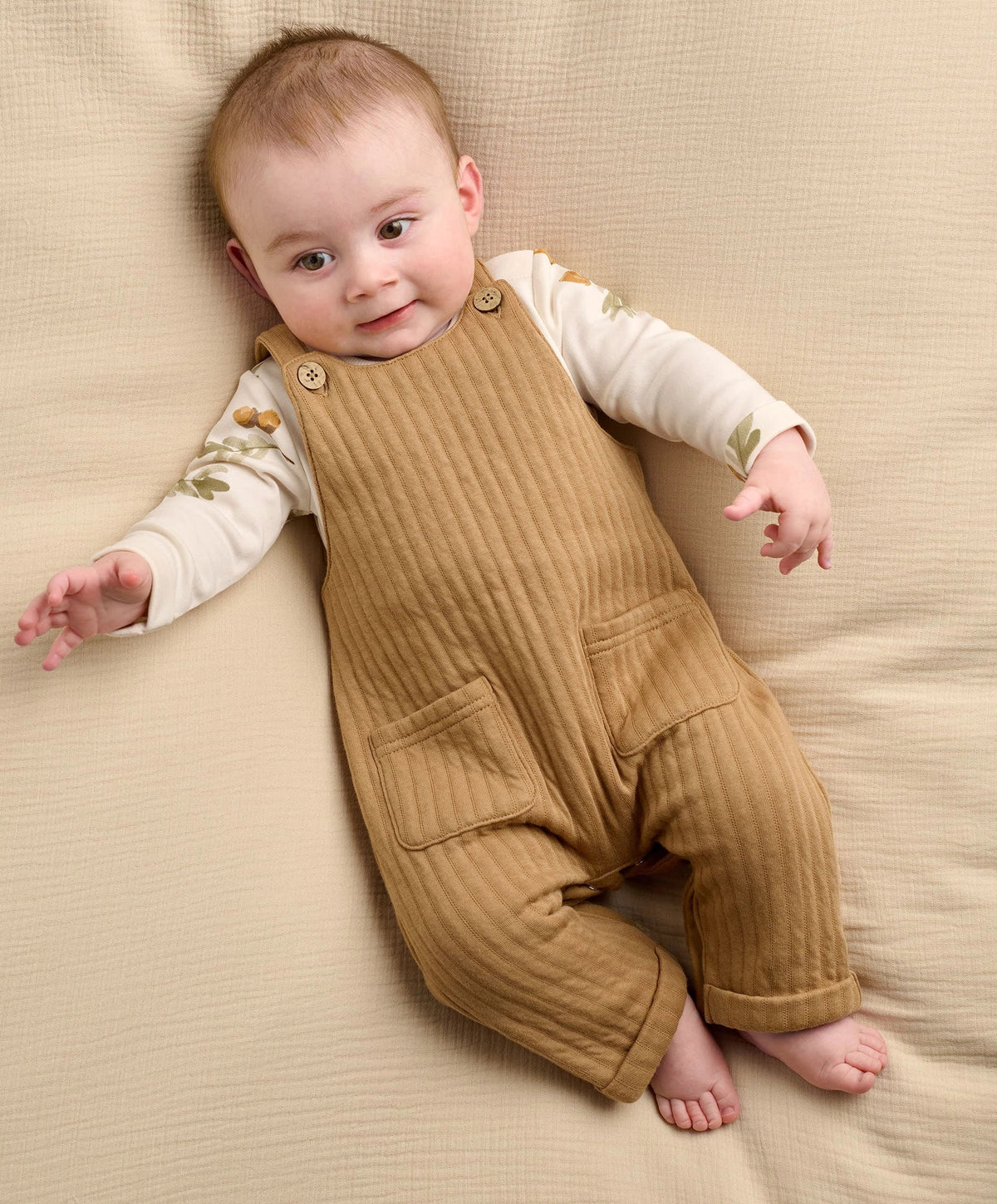 Baby dungaree and bodysuit set on infant: tan ribbed overalls with front pockets