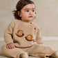 Beige knitted baby set with snail applique sweater and matching pants