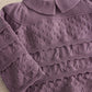 Plum knit sweater top with textured pattern and layered ruffle detail