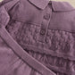 Plum knit cardigan-style top with ribbed collar, buttons, and textured yoke