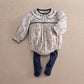 Floral romper with long sleeves, scalloped navy collar, and navy tights