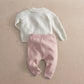 Back view of cream knit cardigan and mauve knit leggings set with ribbed cuffs.