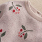 Pink knitted top with berry and leaf print, ribbed crew neckline