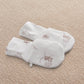 White printed baby mittens with whimsical animal motifs
