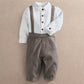 White mock-neck romper with dark herringbone bib and button-up front