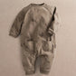 Gray long-sleeve romper with allover snail print and front snap placket