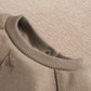 Gray romper neckline with ribbed trim and small button at the back