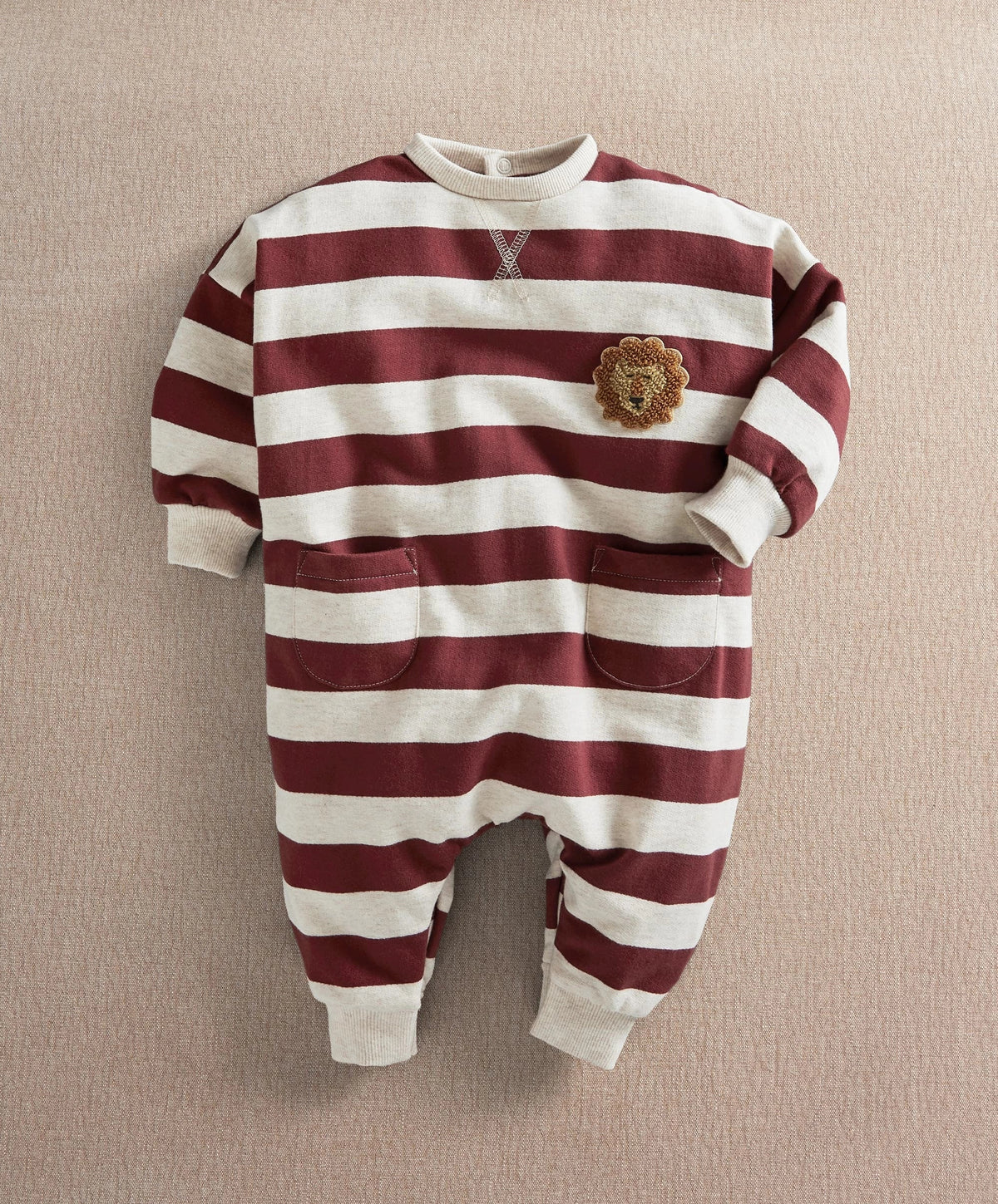 Striped long-sleeve romper with lion applique on chest, burgundy and cream