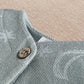 Light blue romper shoulder with stitched collar and round wooden-look button