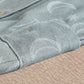 Light blue romper fabric close-up with striped texture and button details