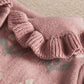 Ribbed knit romper sleeve cuff with gathered ruffle edge