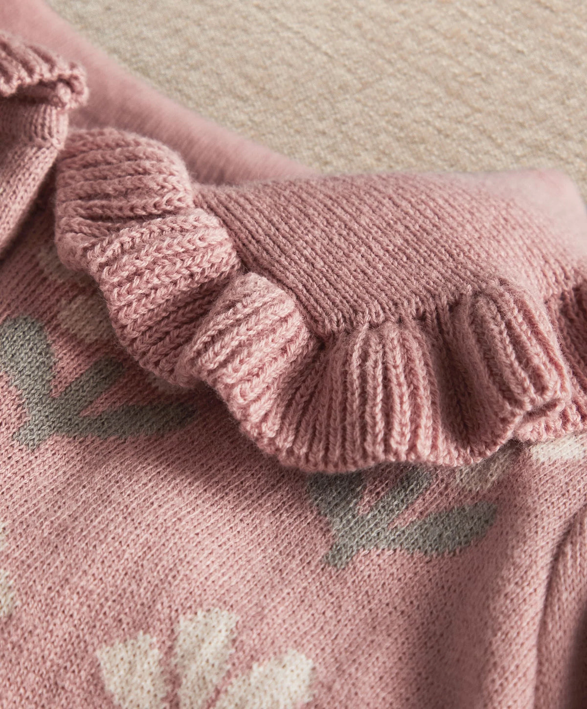 Ribbed knit romper sleeve cuff with gathered ruffle edge