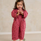 Purple floral short-sleeve romper with button front and patch pockets, long legs