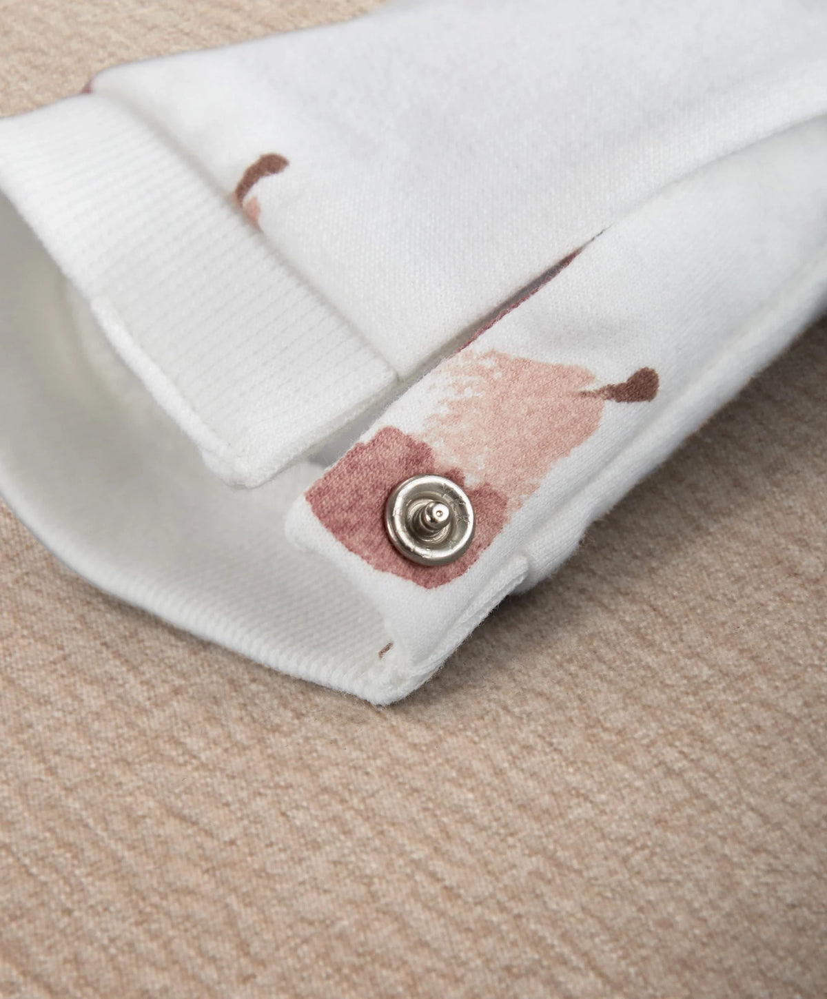 White fruit-print romper footless cuff with snap button detail