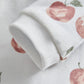 White fruit-print romper sleeve with folded ribbed cuff and fruit motif