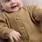 Tan jacket with button placket and small snail embroidery at chest