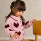 Pink knit heart cardigan with dark red motif, button front, and ribbed collar