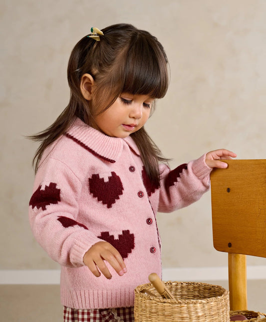 Pink knit heart cardigan with dark red motif, button front, and ribbed collar