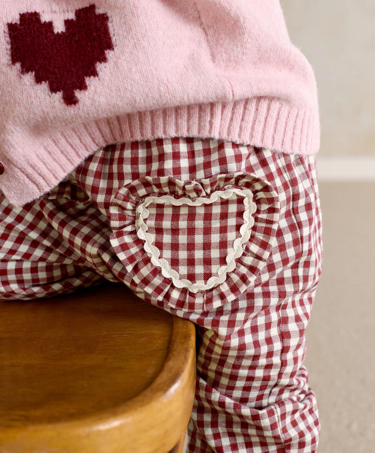 Pink heart cardigan with dark red intarsia and ribbed hem trim