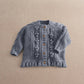 Gray button-front cable-knit cardigan with raised bobble patterns and ribbed neck