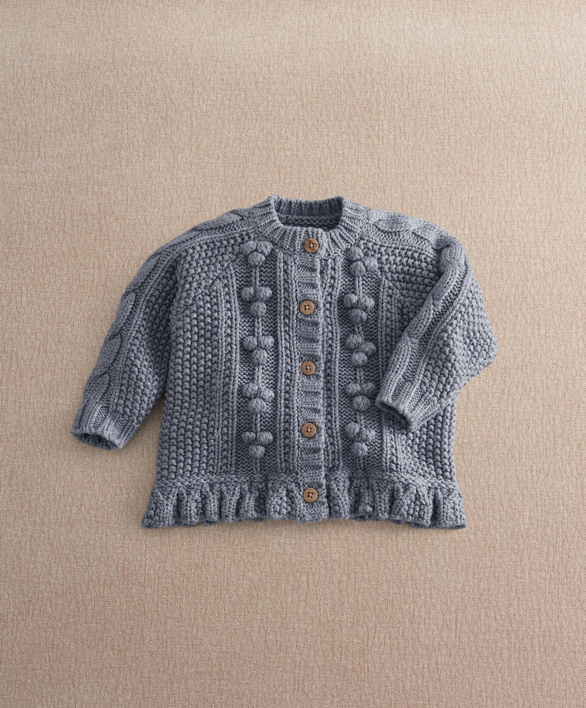 Gray button-front cable-knit cardigan with raised bobble patterns and ribbed neck