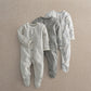 Pack of 3 baby sleepsuits: striped, dino graphic, and grey patterned