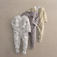 Set of 3 baby sleepsuits: striped, gray horse print, and white horse pattern.