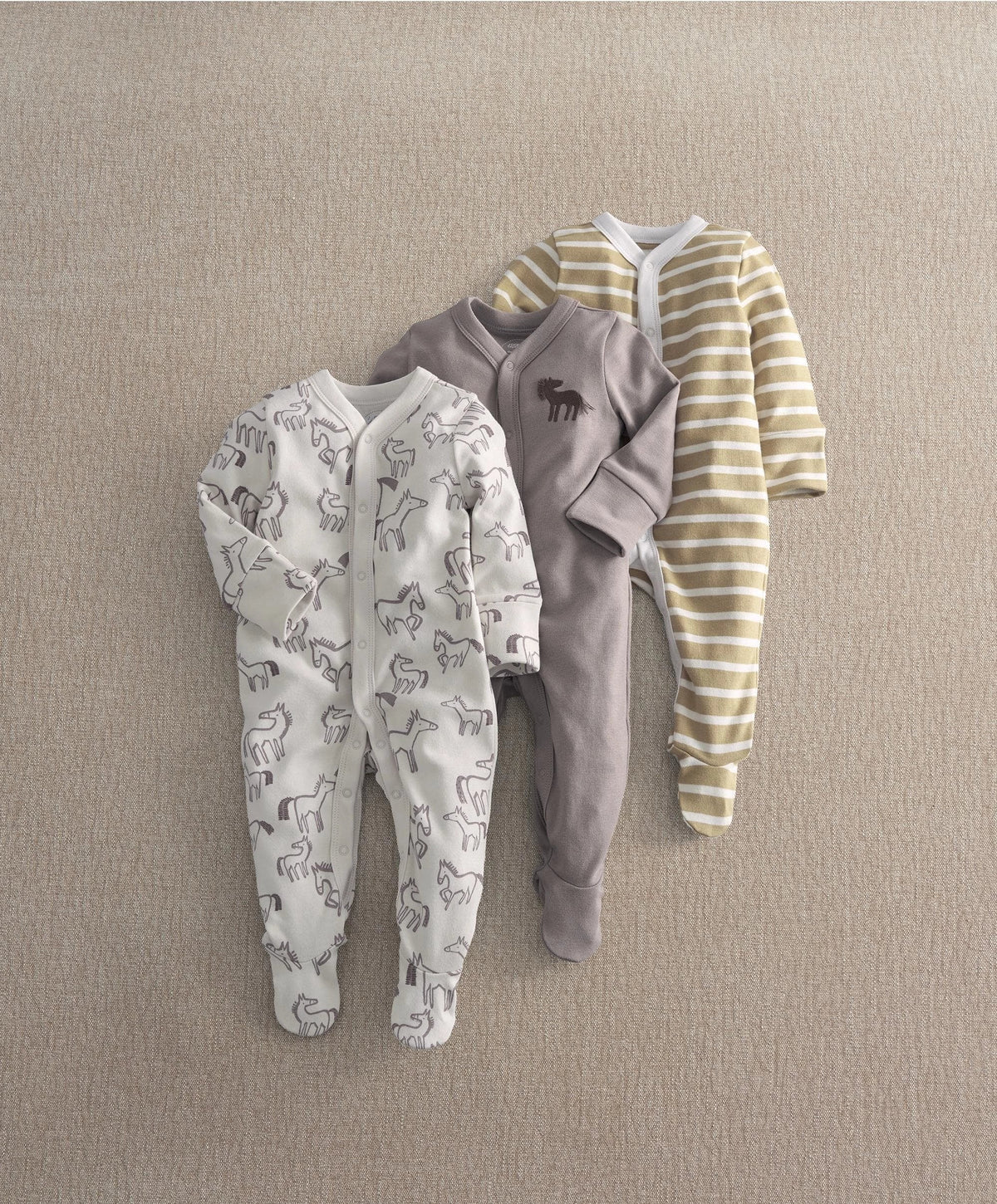 Set of 3 baby sleepsuits: striped, gray horse print, and white horse pattern.