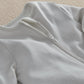 White zip-front sleepsuit with long sleeves and covered foot cuffs