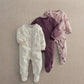 Three-pack baby sleepsuits: white speckle, plum zip, blush floral prints